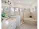 Elegant bathroom featuring a walk-in shower, soaking tub, and stylish tile work at 10509 Winding Stream Way, Bradenton, FL 34212