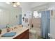 Bright bathroom with a large mirror, vanity, and a shower-tub combination at 10509 Winding Stream Way, Bradenton, FL 34212