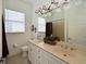Well-lit bathroom with double vanity, neutral tones, and a large mirror for a bright, spacious feel at 10509 Winding Stream Way, Bradenton, FL 34212