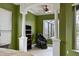 Secondary bedroom with columns, dark bookcase and a black massage chair by the window at 10509 Winding Stream Way, Bradenton, FL 34212