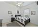 Neutral bedroom with a black and white floral bedspread and a ceiling fan at 10509 Winding Stream Way, Bradenton, FL 34212