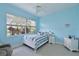 Comfortable bedroom featuring a ceiling fan, ample natural light, and tasteful coastal-inspired decor at 10509 Winding Stream Way, Bradenton, FL 34212