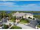 Expansive clubhouse with well-manicured landscaping, palm trees, and waterfront views at 10509 Winding Stream Way, Bradenton, FL 34212