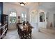 Bright dining room featuring large windows, elegant columns, and decorative accents at 10509 Winding Stream Way, Bradenton, FL 34212