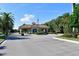 Community entrance featuring a guard house, American flag, and lush landscaping at 10509 Winding Stream Way, Bradenton, FL 34212