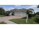 Charming single-story home featuring a well-manicured lawn, mature landscaping and a brick driveway at 10509 Winding Stream Way, Bradenton, FL 34212