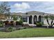 Charming single-story home with well-manicured landscaping, decorative yard ornaments, and a brick walkway at 10509 Winding Stream Way, Bradenton, FL 34212