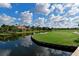 Scenic golf course view from the water featuring well-manicured greens and luxury homes in the backdrop at 10509 Winding Stream Way, Bradenton, FL 34212