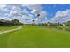 Beautiful golf course view, with lush green grass, a water hazard, and blue skies with puffy white clouds at 10509 Winding Stream Way, Bradenton, FL 34212