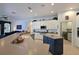 Bright kitchen features white cabinets, stainless steel appliances, and a navy blue center island at 10509 Winding Stream Way, Bradenton, FL 34212