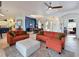 Spacious living room with an orange sofa set and a view into other areas of the home at 10509 Winding Stream Way, Bradenton, FL 34212