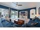 Living room with a large media center and views of the pool from sliding glass doors at 10509 Winding Stream Way, Bradenton, FL 34212