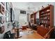 Spacious home office featuring wood floors, built-in bookshelves, and a bright window at 10509 Winding Stream Way, Bradenton, FL 34212