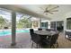 Relaxing patio with a ceiling fan, outdoor seating and a view of the pool and spa at 10509 Winding Stream Way, Bradenton, FL 34212
