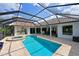 Sparkling pool and spa surrounded by tropical landscaping and a screened enclosure at 10509 Winding Stream Way, Bradenton, FL 34212