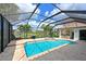 Sparkling pool and spa surrounded by tropical landscaping and a screened enclosure at 10509 Winding Stream Way, Bradenton, FL 34212