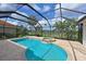 Sparkling pool and spa surrounded by tropical landscaping and a screened enclosure at 10509 Winding Stream Way, Bradenton, FL 34212