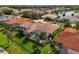 An inviting backyard oasis featuring a screened pool, lush landscaping, and a red tile roof at 10509 Winding Stream Way, Bradenton, FL 34212