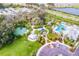 Aerial shot of community amenities including playground, pool, and tennis courts with nearby parking at 10914 Blue Magnolia Ln, Parrish, FL 34219