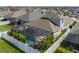 Aerial view of a fenced yard with a screened in pool, umbrella and seating at 10914 Blue Magnolia Ln, Parrish, FL 34219