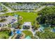 Aerial shot of a community park featuring a playground, pavilion, and open green space at 10914 Blue Magnolia Ln, Parrish, FL 34219
