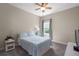 Comfortable bedroom with a ceiling fan, large window, and a cozy bed, perfect for relaxing after a long day at 10914 Blue Magnolia Ln, Parrish, FL 34219