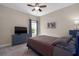 Comfortable bedroom featuring a ceiling fan, a large window, and a cozy bed, perfect for relaxing at 10914 Blue Magnolia Ln, Parrish, FL 34219