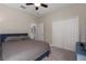 Cozy bedroom with a ceiling fan, spacious closet, and a connecting bathroom for added convenience at 10914 Blue Magnolia Ln, Parrish, FL 34219