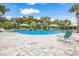 Community pool featuring lounge chairs, shaded cabanas, and well-maintained surrounding landscaping at 10914 Blue Magnolia Ln, Parrish, FL 34219