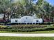 Silverleaf Real Communities sign is surrounded by manicured landscaping, grass and mature palm trees at 10914 Blue Magnolia Ln, Parrish, FL 34219