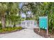 Community dog park area features a double-gated entry, shade trees, seating, and clearly posted park rules at 10914 Blue Magnolia Ln, Parrish, FL 34219