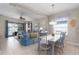 Open-concept living and dining area showcasing stylish furniture, blue accents, and sliding glass doors at 10914 Blue Magnolia Ln, Parrish, FL 34219