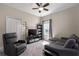 Relaxing living room with a plush recliner, comfortable seating, and a large TV for entertainment at 10914 Blue Magnolia Ln, Parrish, FL 34219