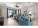 Bright living room featuring tile floors, comfortable seating, and a view of the pool through sliding glass doors at 10914 Blue Magnolia Ln, Parrish, FL 34219