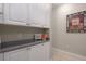 Well-organized pantry with white cabinets, granite countertops, and ample storage space for kitchen essentials at 10914 Blue Magnolia Ln, Parrish, FL 34219