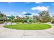 Community playground with colorful play structures and a grassy area, perfect for outdoor fun at 10914 Blue Magnolia Ln, Parrish, FL 34219