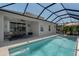 Screened in pool with outdoor furniture and palm trees at 10914 Blue Magnolia Ln, Parrish, FL 34219