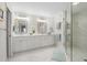 Elegant bathroom with double vanity, modern fixtures, and a glass-enclosed shower at 121 Tidy Island Blvd, Bradenton, FL 34210