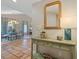 Inviting entryway with Spanish tile flooring, decorative table, and view into a formal dining area at 121 Tidy Island Blvd, Bradenton, FL 34210