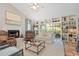 Cozy living room with a fireplace, built-in shelving, and sliding glass doors at 121 Tidy Island Blvd, Bradenton, FL 34210