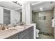 Well-lit bathroom featuring a dual sink vanity, a glass-enclosed shower, and modern fixtures at 1249 Dockside Pl # 110, Sarasota, FL 34242