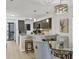 Dining area open to the kitchen with bar seating and a view to the living room at 1249 Dockside Pl # 110, Sarasota, FL 34242