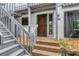 Townhome entrance featuring a stairway, door, and decorative stone landscaping at 1249 Dockside Pl # 110, Sarasota, FL 34242