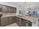Modern kitchen with granite counters, stainless steel appliances, and a view to the living room at 1249 Dockside Pl # 110, Sarasota, FL 34242