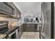 Well-lit kitchen with granite counters, stainless steel appliances, and tile backsplash at 1249 Dockside Pl # 110, Sarasota, FL 34242