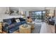 Inviting living room features stylish decor and a comfortable blue sofa near the sliding doors to a balcony at 1249 Dockside Pl # 110, Sarasota, FL 34242