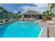 Community pool and spa with tennis courts on a sunny day at 1249 Dockside Pl # 110, Sarasota, FL 34242