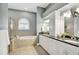 A stunning bathroom offers a soaking tub with a shower and a dual-sink vanity with granite countertop at 12622 Safe Harbour Dr, Cortez, FL 34215