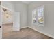 Bright bedroom featuring a large window with plantation shutters and stylish hardwood floors at 12622 Safe Harbour Dr, Cortez, FL 34215