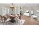 Elegant dining area featuring luxury vinyl floors, a modern chandelier, and a seamless flow into the living spaces at 12622 Safe Harbour Dr, Cortez, FL 34215